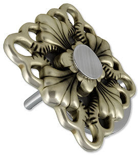 A metal component with the nail head of a rivet shown on the front.